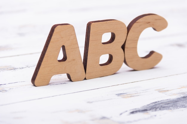 ABC letters on white wooden background. Education concept. Free copy space.