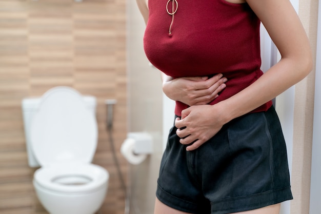 Abdominal pain of woman, stomachache diarrhea symptom, menstrual period cramp or food poisoning. health care concept.