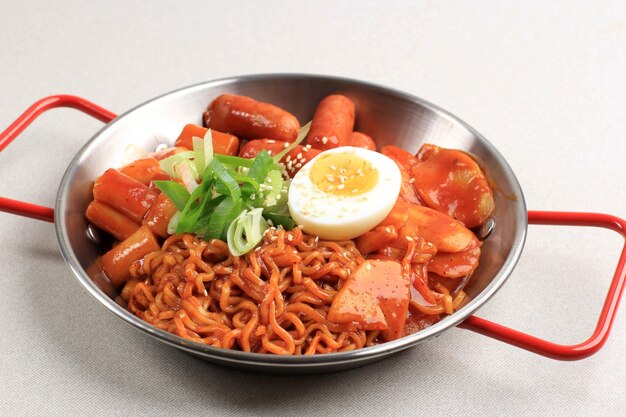 Abokki (Ramen or Korean Instant noodle and Tteokbokki) in spicy korean sauce, with Half Boiled Egg