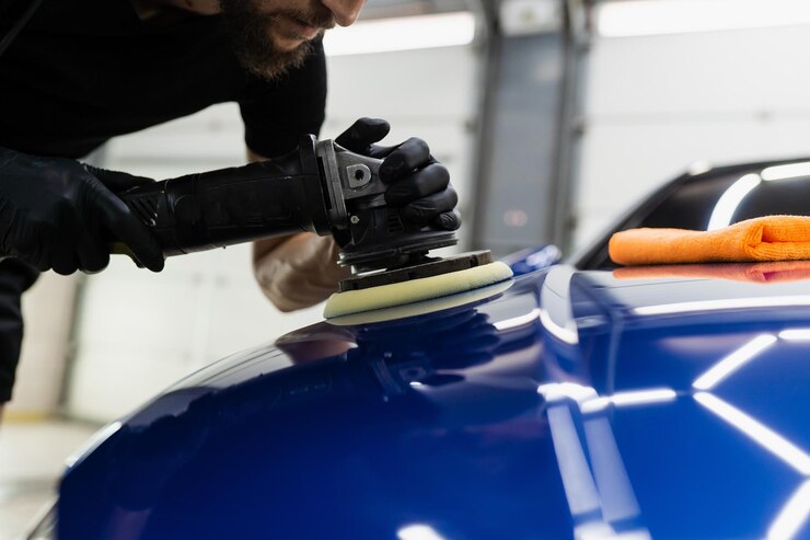 Abrasive paste car polishing with orbital polisher for remove scratches Worker of detailing auto service making final polishing for car