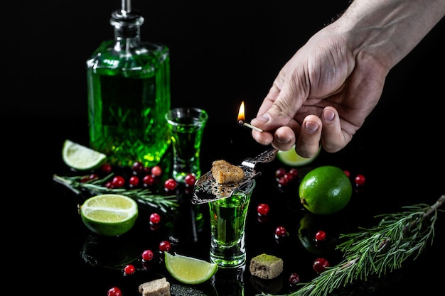 Absinthe poured into a glass alcoholic drink with brown sugar and lime Absinthe or mint liquor shot