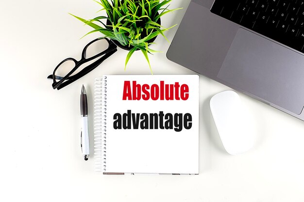 ABSOLUTE ADVANTAGE text on notebook with laptop mouse and pen