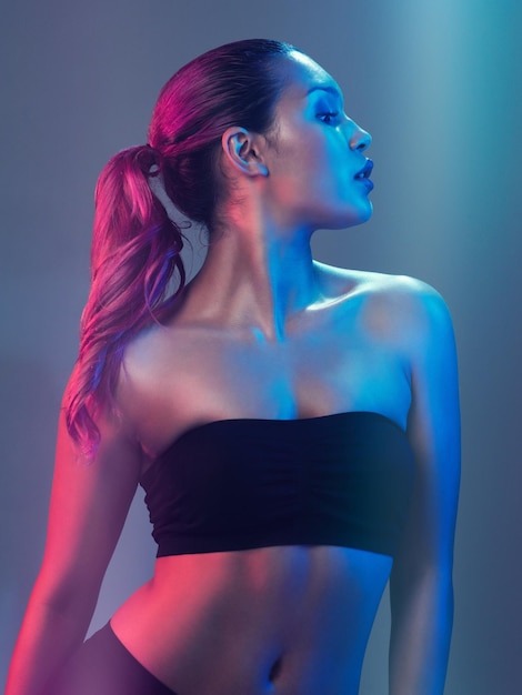 Absolutely gorgeous Studio shot of a beautiful young woman posing against a multi colored background