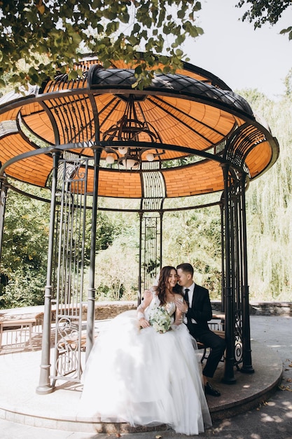 Absolutely stunning young wedding couple walking and posing in the forest.