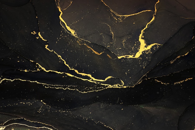 Photo abstarct fluid ink background with black and golden splashes