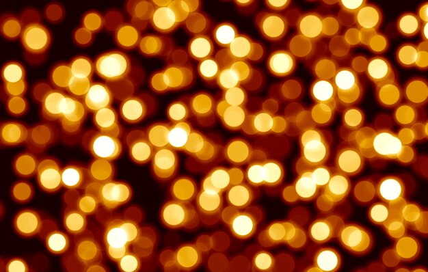 Abstrac festive golden blurred bokeh background on black