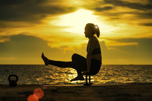 Abstrac.    Silhouette yoga.Portrait of young woman practicing yoga at the sea.Relax at the sea.Meditation