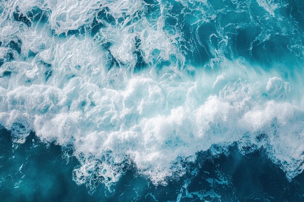 An Abstract aerial texture of white ocean wave foam over turquoise waters