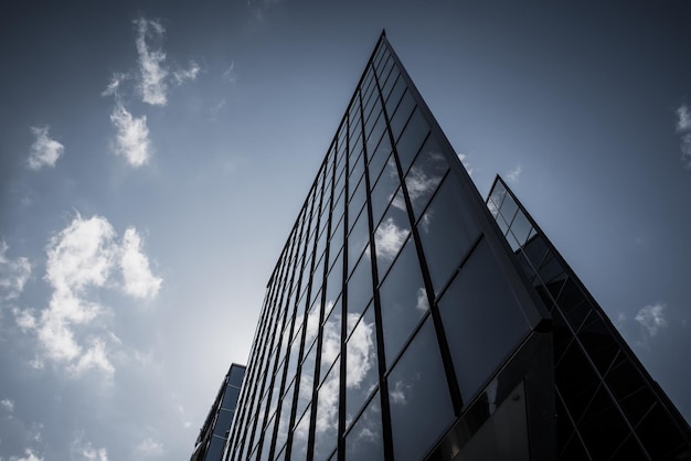 Abstract architecture background with blue sky and modern office building with reflection in the window glass