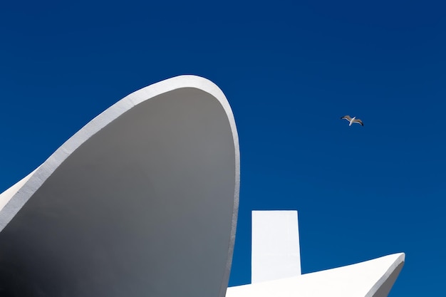 Abstract architecture with brightly lit parts of building against blue clear sky Baku Azerbaijan