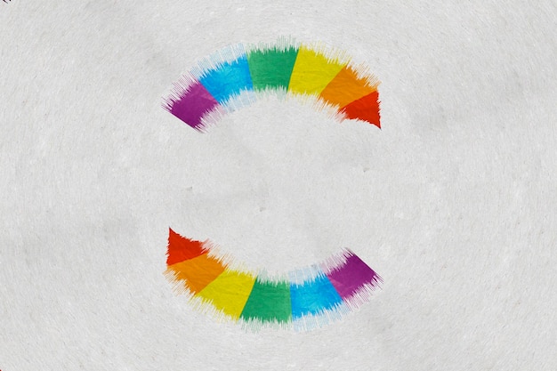 An abstract arrow shapes circle in the colors of a rainbow flag