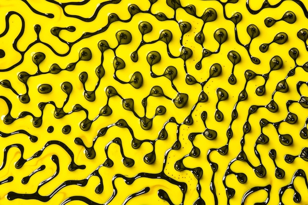 Photo abstract art. swirls, artistic design with black and yellow oil colors forming amazing intricate structures with ferrofluid.