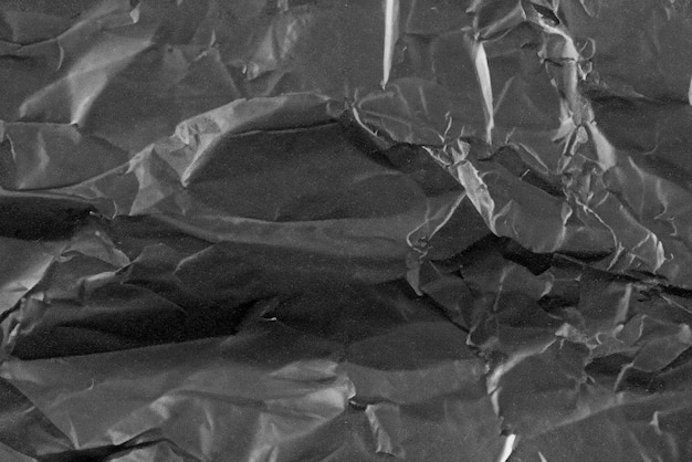Абстрактный фон скрученная пластиковая пленка текстура черный мусорный мешок