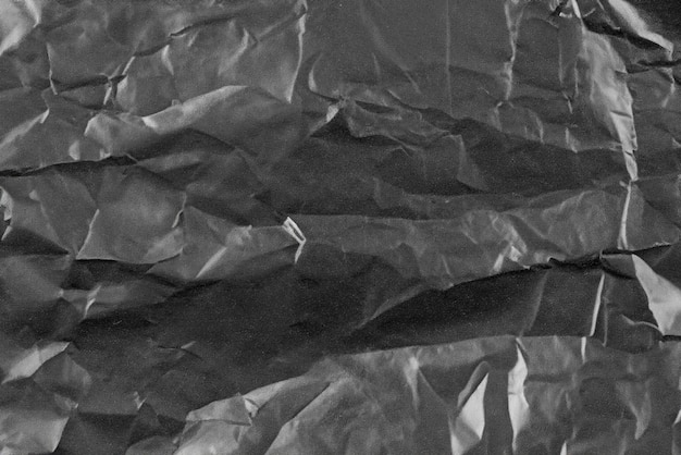 Абстрактный фон скрученная пластиковая пленка текстура черный мусорный мешок