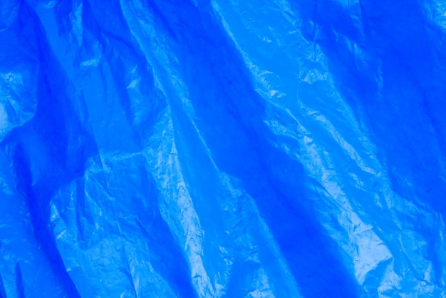 Abstract background crumpled plastic film texture blue garbage bag