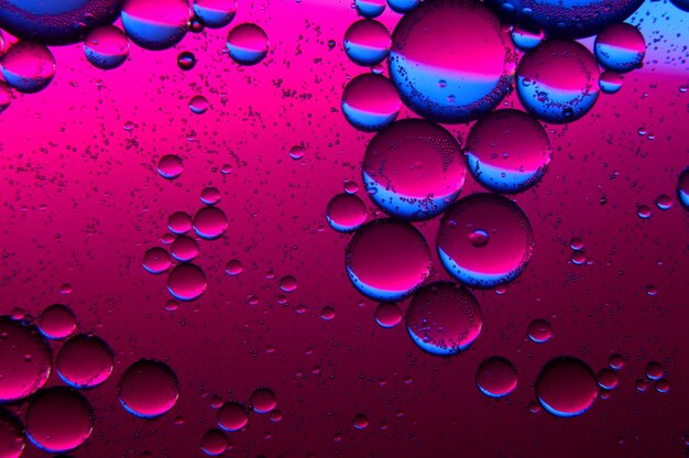 Photo abstract background. drops of oil on water, blue and red. macro.