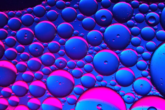 Abstract background. drops of oil on water, blue and red. macro.