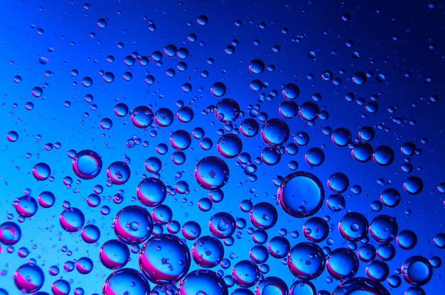 Abstract background. drops of oil on water, blue and red. macro.