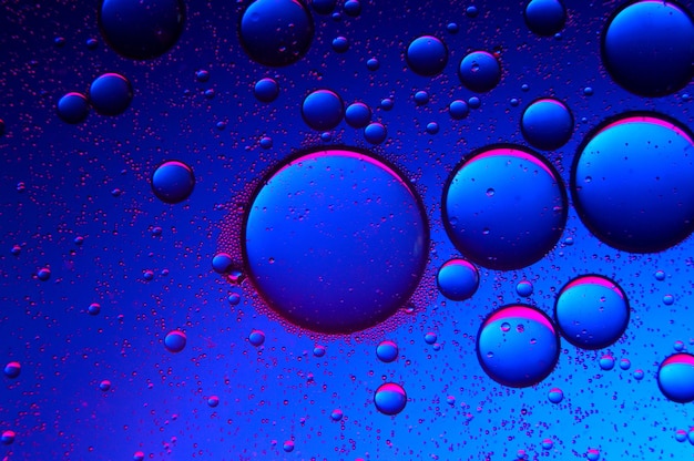 Abstract background. drops of oil on water, blue and red. macro