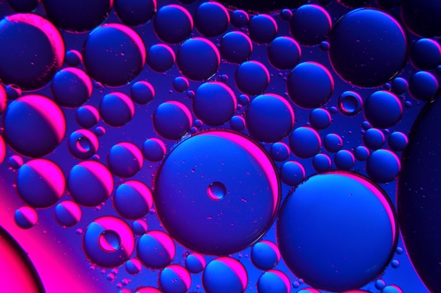 Photo abstract background. drops of oil on water, blue and red. macro.