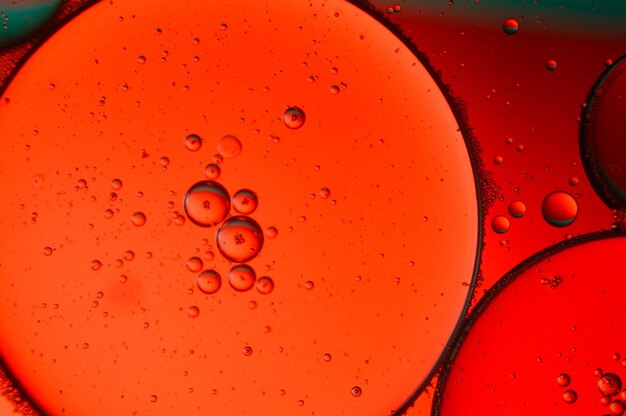 Abstract background. drops of oil on water, red and green color. macro.