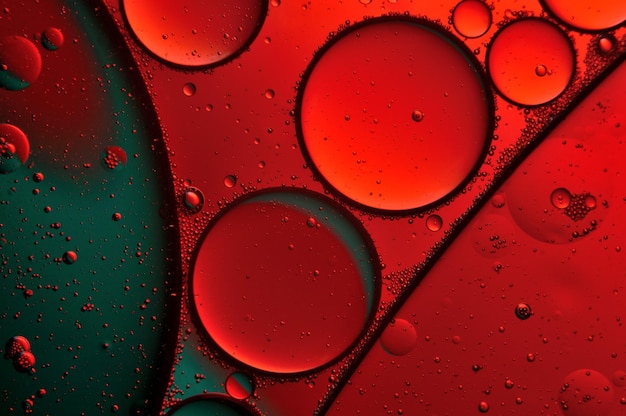 Abstract background drops of oil on water red and green color macro