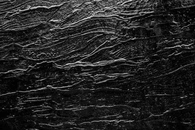 Abstract background from black rock texture plate decorated on wall