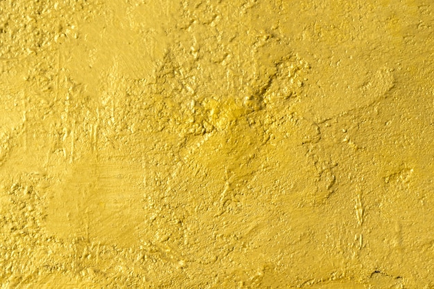 Abstract background from golden painted on concrete wall