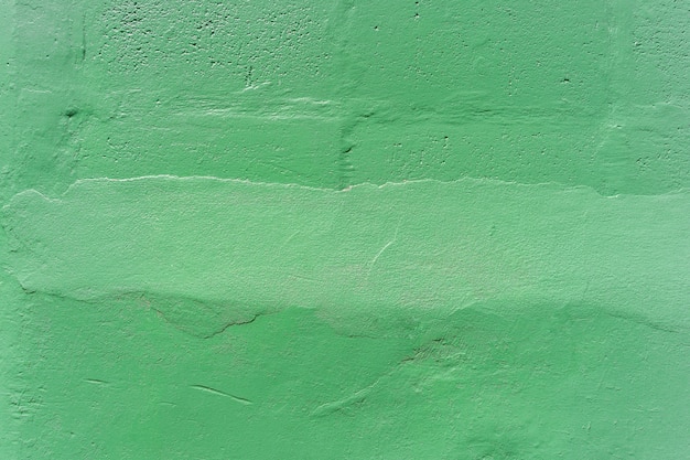 Abstract background from green painted on concrete wall with scratched.