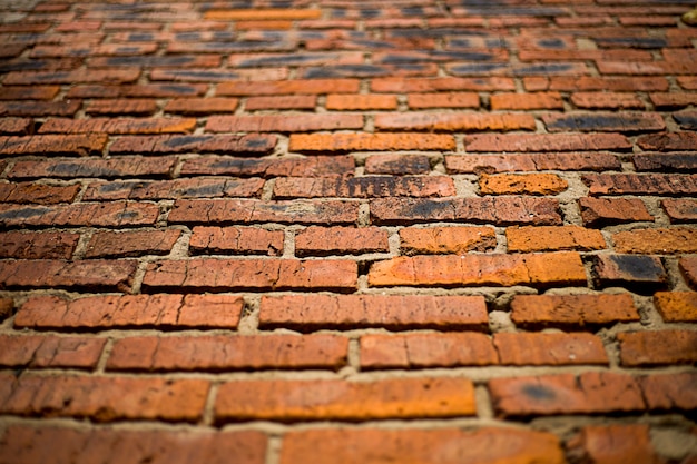 The abstract background is an old brick wall