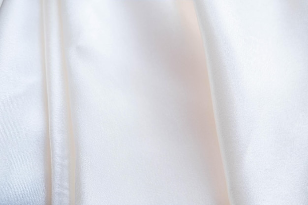 Абстрактный фон из роскошной ткани сложенной текстильной или жидкой волновой или волнистой складки шелковой текстуры сатин