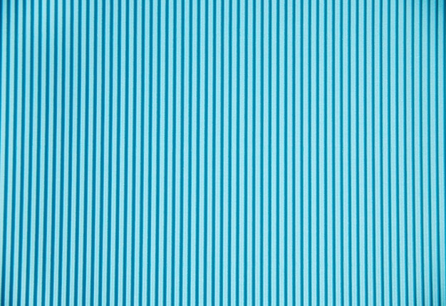 Photo abstract background made of corrugated paper for blue application space for text texture vertical stripes