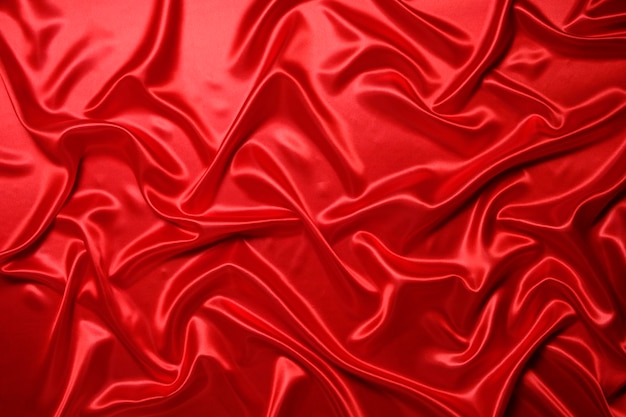 Abstract background made of red silk wavy fabric