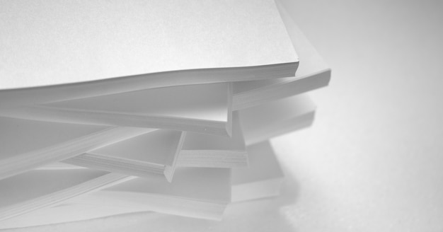 Abstract background, minimalism. Several stacks of white paper for photocopier, on a white background. Office work concept.