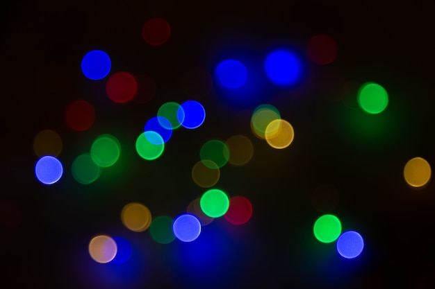 Abstract background, multicolored bokeh on a black background.