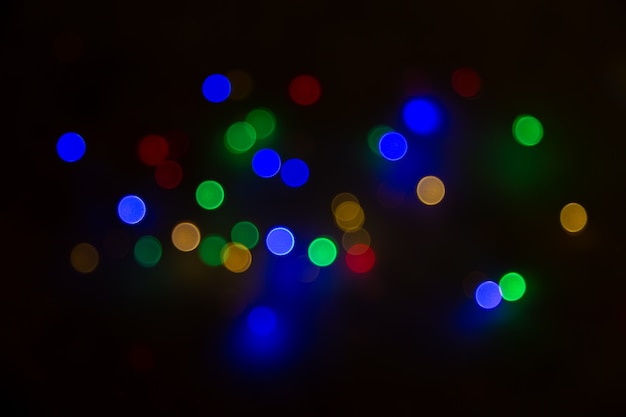 Abstract background, multicolored bokeh on a black background.