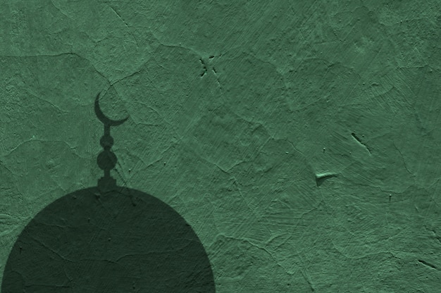 사진 부드러운 녹색 콘크리트 벽과 모스크 돔의 그림자의 추상 배경