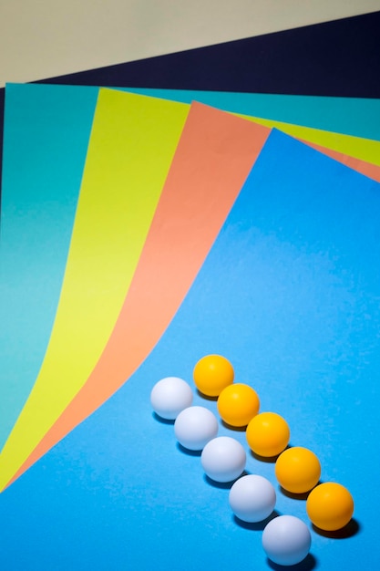 Abstract background of sheets of colored paper with balls