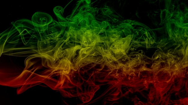 Photo abstract background smoke curves and wave reggae colors green yellow red colored in flag of reggae music