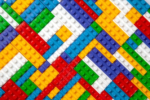 Abstract background texture of colored constructor blocks Background of colorful plastic part of constructor Pile of colored toy bricks