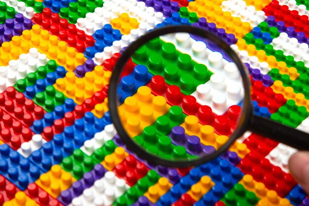 Abstract background texture of colored constructor blocks Background of colorful plastic part of constructor Pile of colored toy bricks