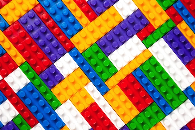 Abstract background texture of colored constructor blocks Background of colorful plastic part of constructor Pile of colored toy bricks