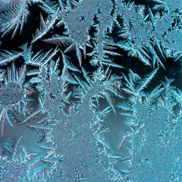 Abstract background texture of the ice patterns on glass, square photo