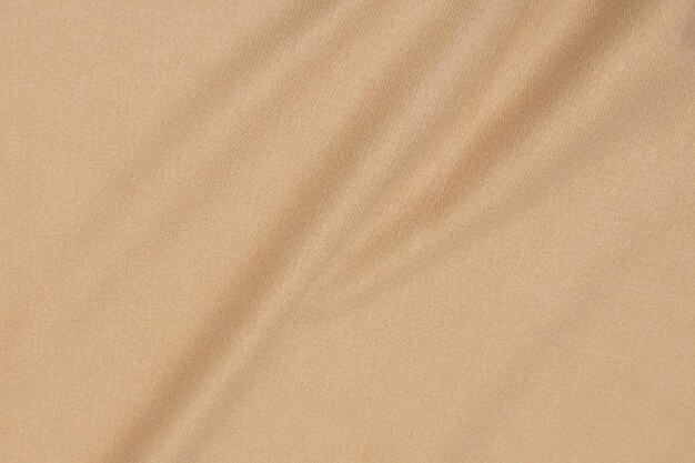 Photo abstract background texture of natural beige or brown colour fabric fabric texture of natural cotton or linen silk or satin wool or jersey textile material luxurious canvas background