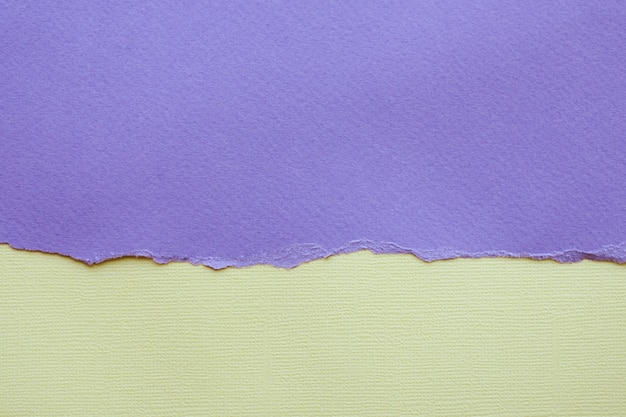 Abstract background and texture. Torn lilac paper and light yellow textured paper.