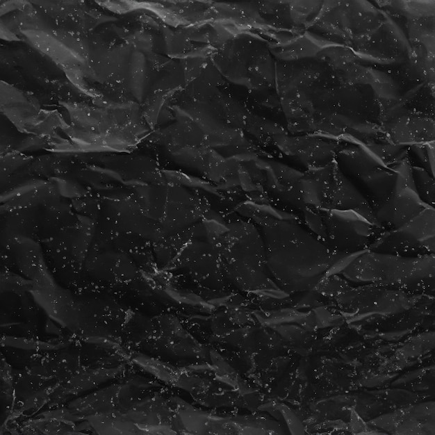 抽象的な背景 折りたたまれた黒い紙の質感のある表面