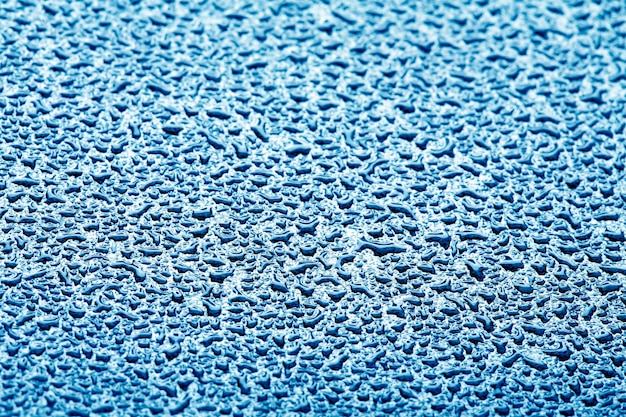 Abstract background water drops on blue glass or metal