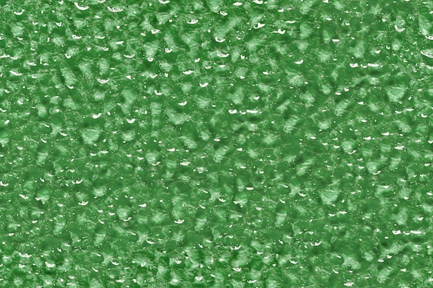 Abstract background water drops on green glass or metal seamless texture