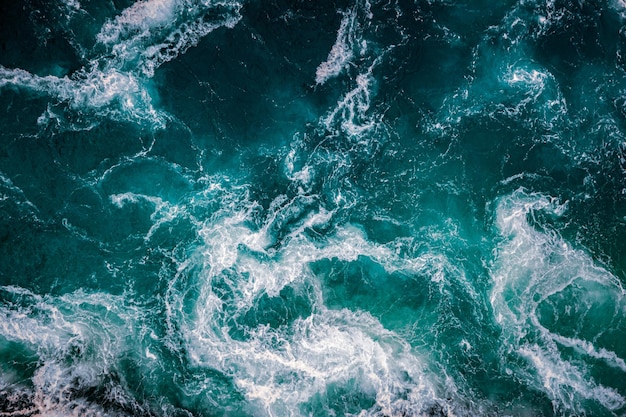 Abstract background. Waves of water of the river and the sea meet each other during high tide and low tide. Whirlpools of the maelstrom of Saltstraumen, Nordland, Norway