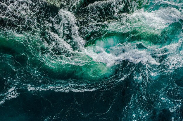 Abstract background Waves of water of the river and the sea meet each other during high tide and low tide Whirlpools of the maelstrom of Saltstraumen Nordland Norway